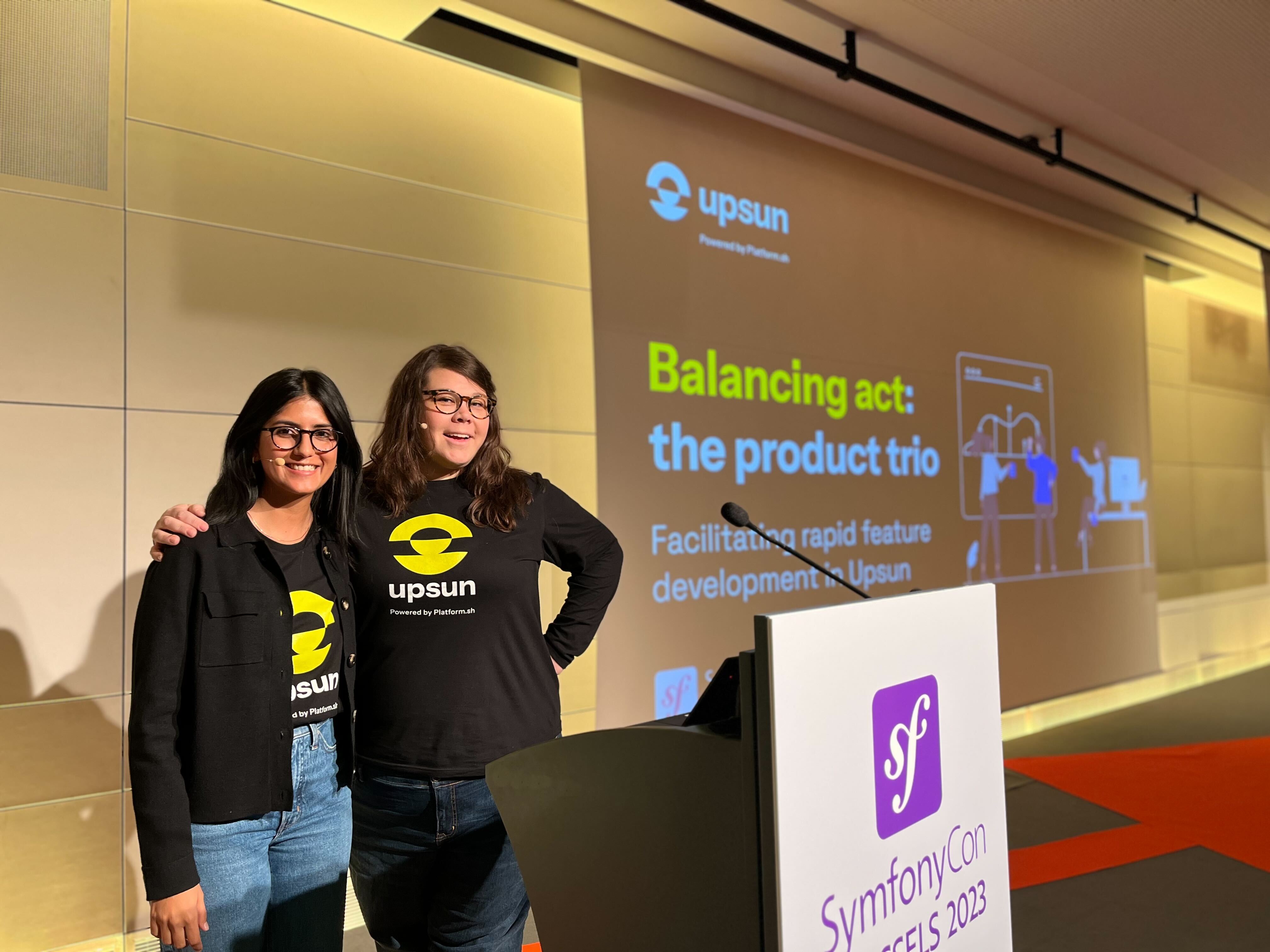 A photo of Sukhman Virk, Product Director at Platform.sh, and Shawna Spoor, Engineering Director at Platform.sh, preparing to present their talking session on the product trio at SymfonyCon 2023. Not pictured, Natalie Harper, VP of Product Design, who also presented virtually.